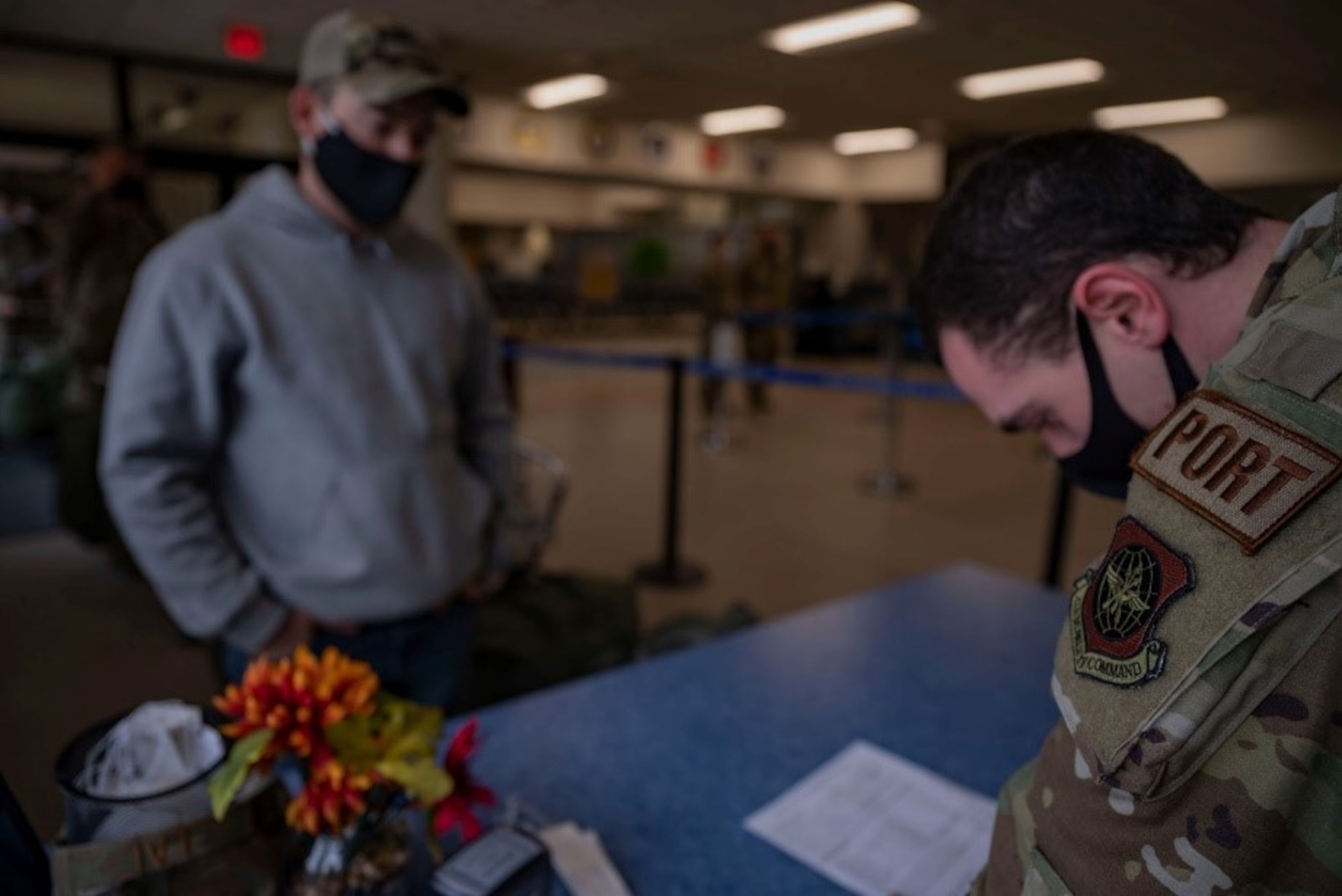 Team McChord Airmen simulate passenger check-in procedures during Patriot Express training at Joint Base Lewis-McChord, Washington, May 4, 2022. The PE mission is a commercial charter mission supporting official-duty travelers and their families to overseas locations, operating out of the McChord Passenger Terminal for the first time. (U.S. Air Force photo by Airman 1st Class Charles Casner)