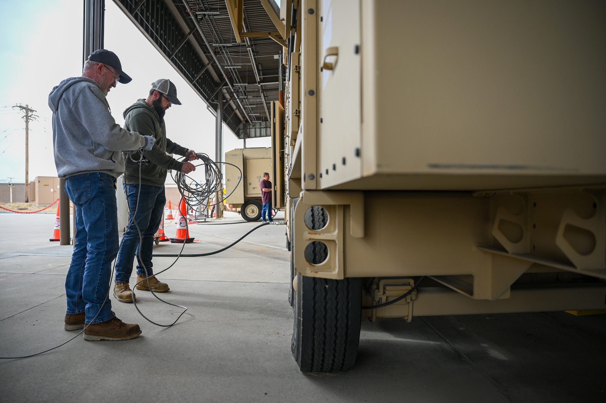 Left, Paul Williams and Abe Erwin, 526th Electronics Maintenance Squadron, prepare a Base Expeditionary Airfield Resources (BEAR) power unit for testing at Hill Air Force Base, Utah, April 26, 2022. The 526th EMXS activated a new maintenance workload on BEAR units after successfully testing the unit's first repaired asset. BEAR power units are used to power U.S. Air Force forward operating bases. (U.S. Air Force photo by R. Nial Bradshaw)