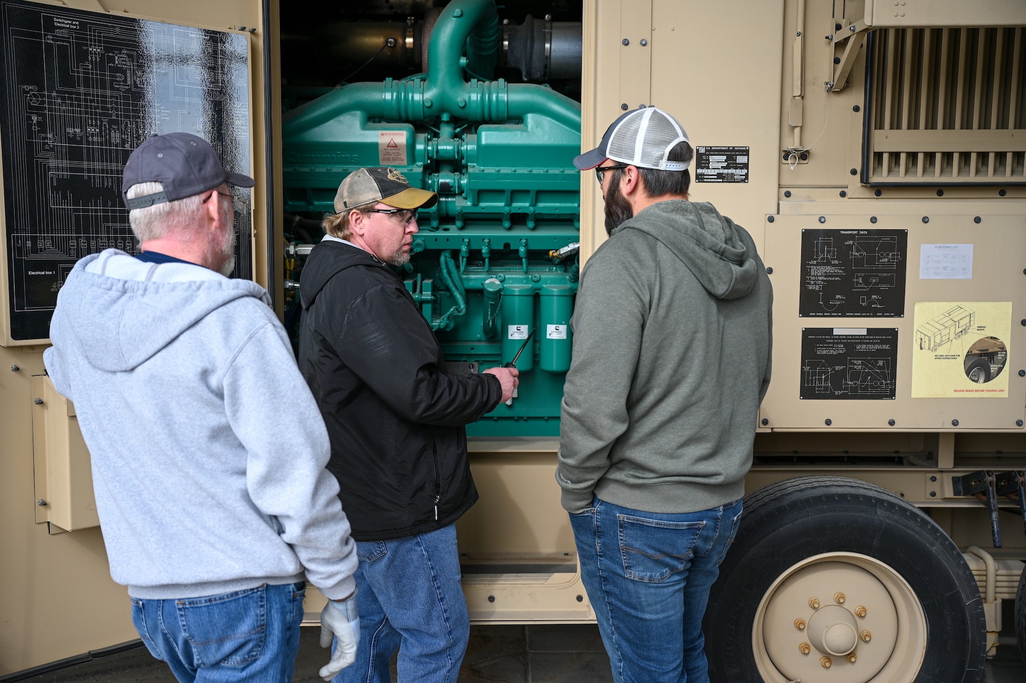 Center, Shane Ott, 526th Electronics Maintenance Squadron, inspects a Base Expeditionary Airfield Resources (BEAR) power unit during validation and verification testing at Hill Air Force Base, Utah, April 26, 2022. The 526th EMXS activated a new maintenance workload on BEAR units after successfully testing the unit's first repaired asset. BEAR power units are used to power U.S. Air Force forward operating bases. (U.S. Air Force photo by R. Nial Bradshaw)