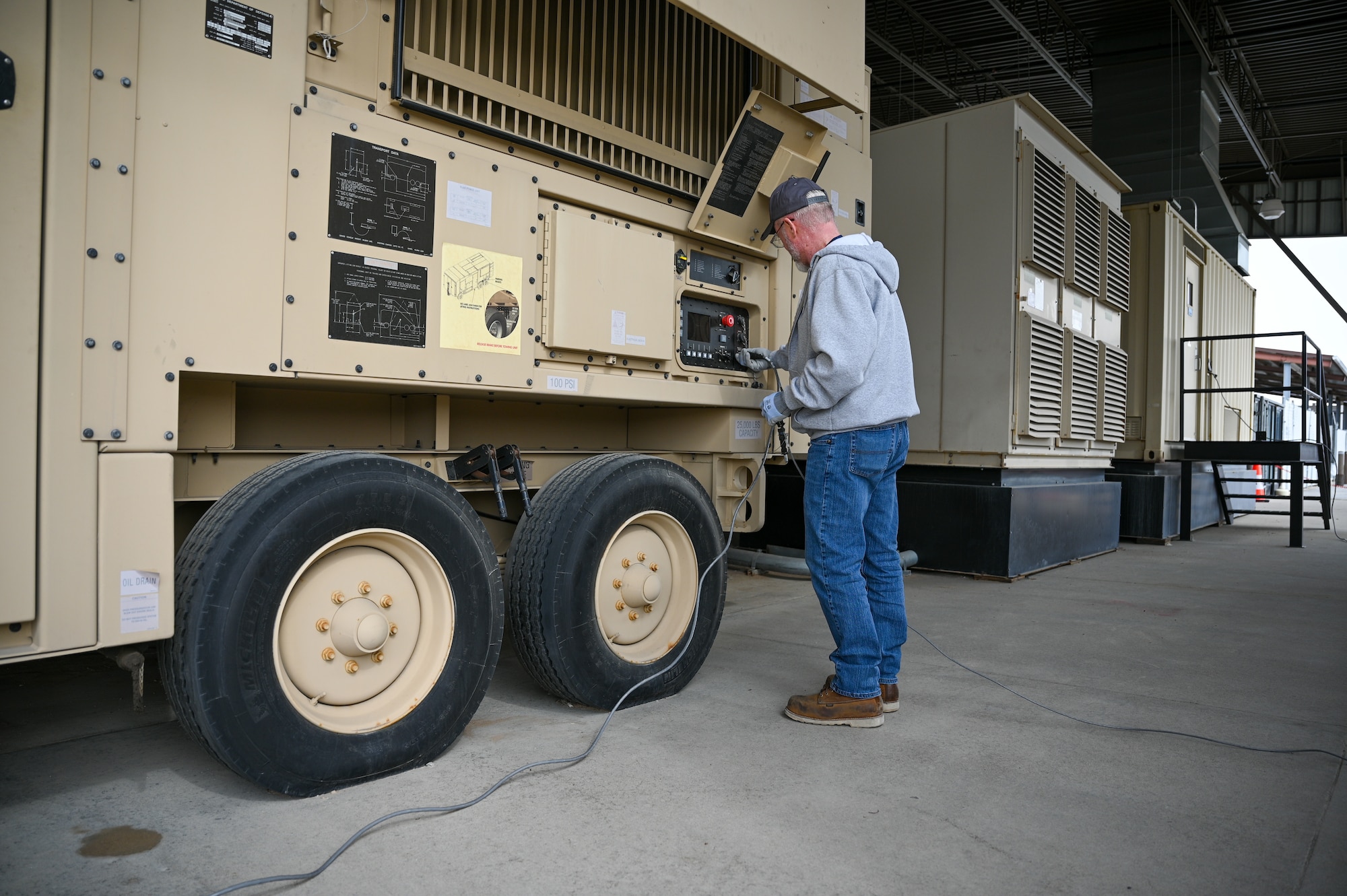 Paul Williams, 526th Electronics Maintenance Squadron, prepares a Base Expeditionary Airfield Resources (BEAR) power unit for testing at Hill Air Force Base, Utah, April 26, 2022. The 526th EMXS activated a new maintenance workload on BEAR units after successfully testing the unit's first repaired asset. BEAR power units are used to power U.S. Air Force forward operating bases. (U.S. Air Force photo by R. Nial Bradshaw)