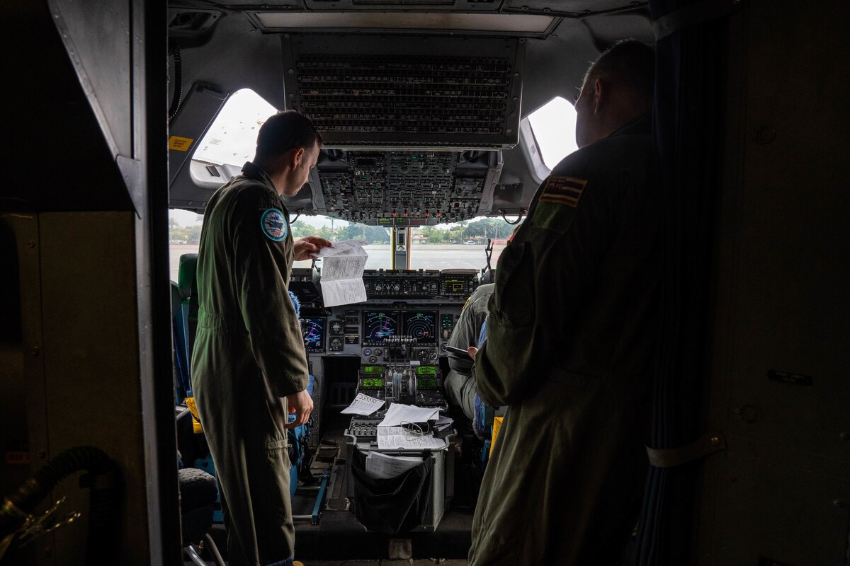 A U.S. Air Force C-17 Globemaster III aircrew review the flight plane and conduct pre-flight inspections before takeoff during Exercise Global Dexterity 2022 Joint Base Pearl Harbor-Hickam, Hawaii, May 4, 2022. The 15th Wing hosted the Royal Australian Air Force as part of Exercise Global Dexterity 2022, where U.S. and Australian C-17s and aircrew trained and flew side-by-side to learn from each other to better their airlift capabilities. (U.S. Air Force photo by Airman 1st Class Makensie Cooper)