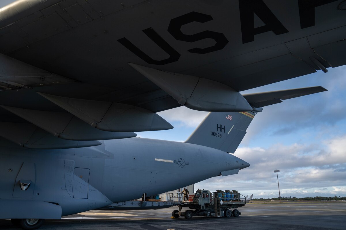 A U.S. Air Force C-17 Globemaster III is loaded on the flightline in preparation for an airdrop during Exercise Global Dexterity 2022 at Joint Base Pearl Harbor-Hickam, Hawaii, May 4, 2022. The Royal Australian Air Force visited JBPHH to join both active duty and National Guard C-17s for training missions around the Hawaiian Islands to develop tactical airlift and airdrop capabilities. (U.S. Air Force photo by Airman 1st Class Makensie Cooper)