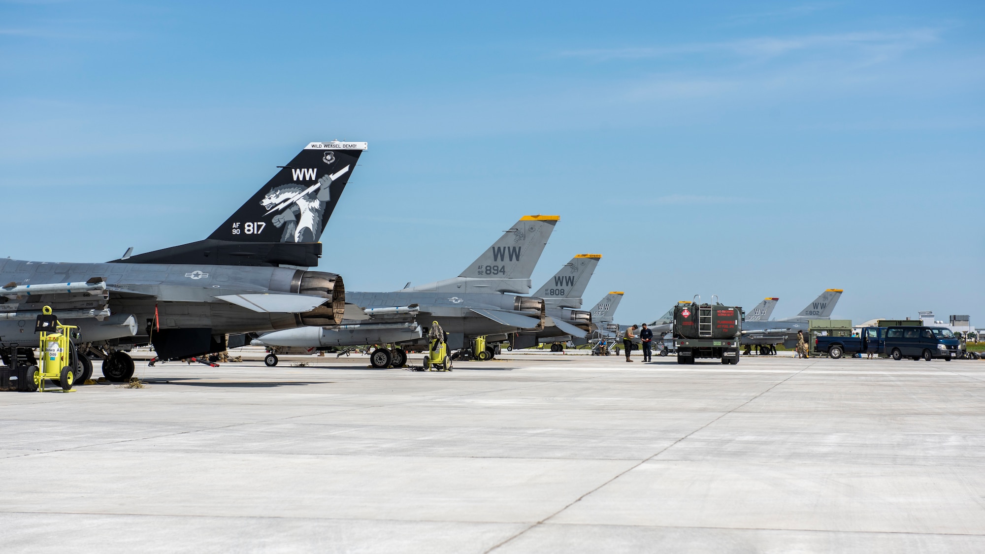 F-16 Fighting Falcon jets receive fuel from a refueling truck