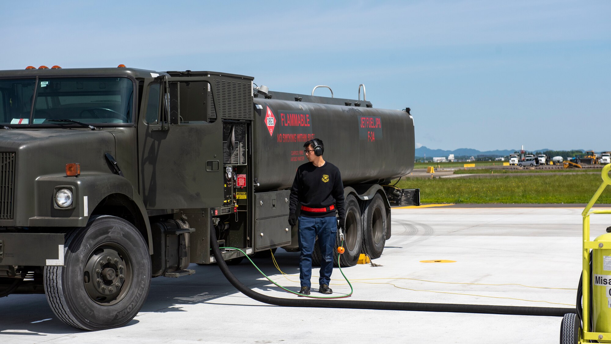 An operator monitors a refueling truck