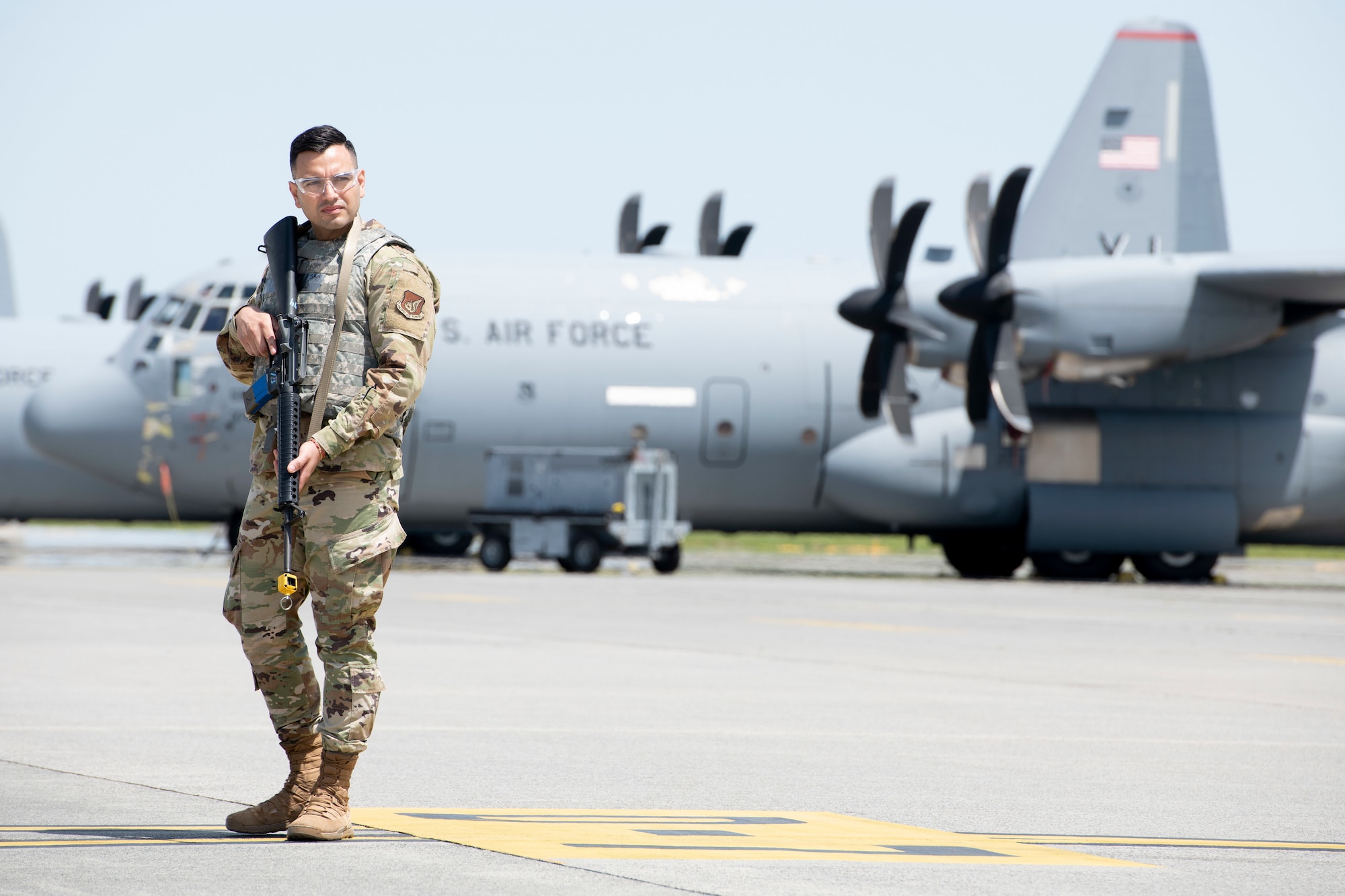 Senior Airman Raymundo Valero Delgado, 374th Comptroller Squadron financial operations technician, stands ready to defend a C-130J Super Hercules during the fly-away security training at Yokota Air Base, Japan, May 10, 2022. The 374th Security Forces Squadron conducted fly-away security training as part of a training during the exercise week. This training assessed Yokota's ability to perform Agile Combat Employment across a range of military operations in a complex and dynamic international security environment. (U.S. Air Force photo by Machiko Arita)