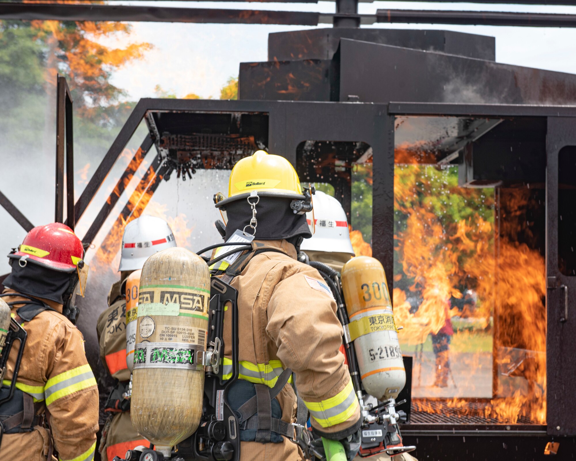 Firefighters with the 374th Civil Engineer Squadron Fire Department and Tokyo Fire Department, Fussa Fire Station, spray an aircraft fire trainer with water during a major accident response exercise at Yokota Air Base, Japan, May 11, 2022. The MARE tested the base’s response to a simulated F-16 Fighting Falcon crash and the ability to collaborate with mission partners. Due to the support of Naval Air Facility Atsugi, Commander Fleet Activities Yokosuka, Misawa Air Base and Tokyo Fire Department, Fussa Fire Station, this was the largest MARE in Yokota history. (U.S. Air Force photo by Machiko Arita)