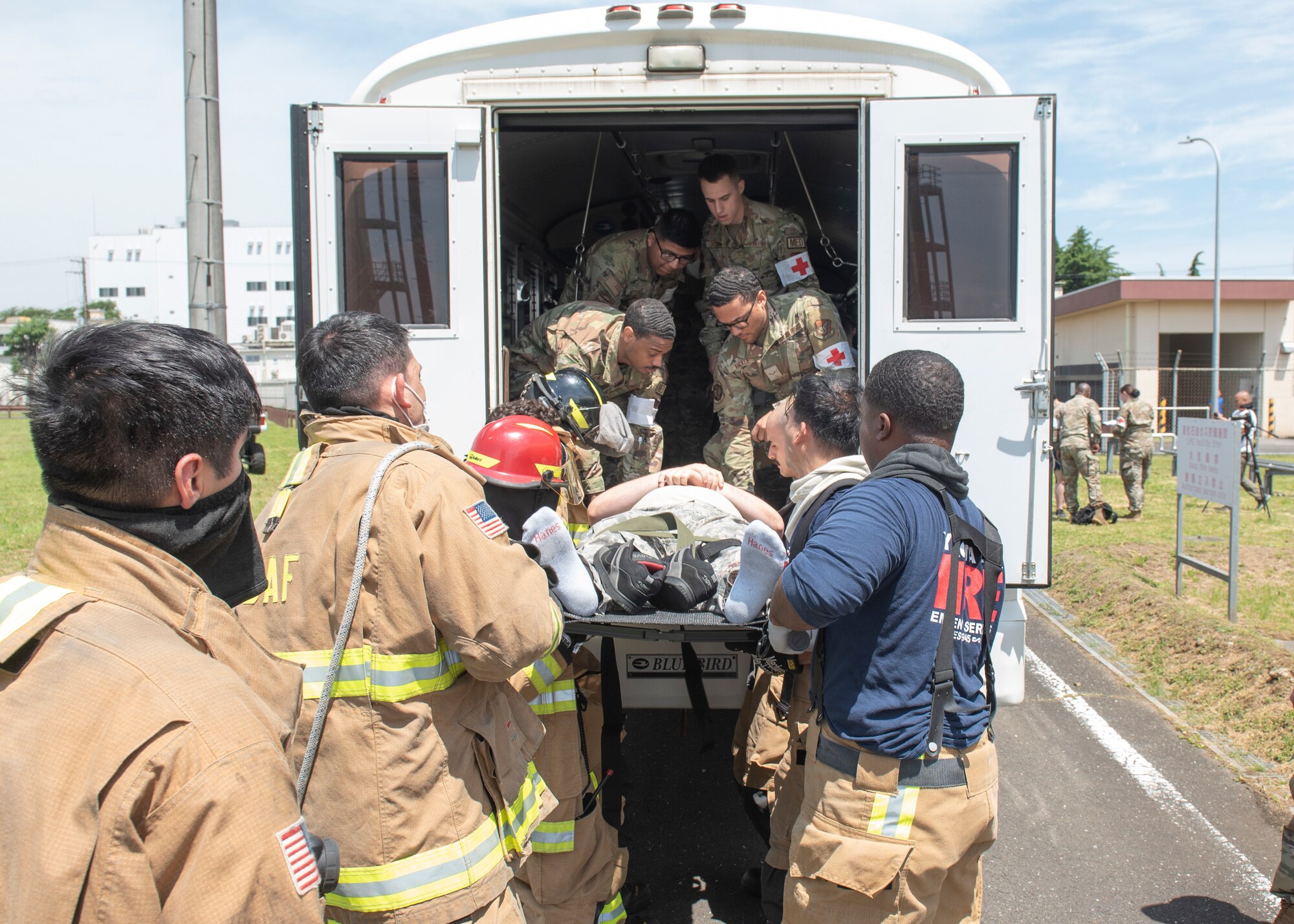Members of the 374th Medical Group and 374th Civil Engineer Squadron Fire Department prepare to transport a simulated injured person during a major accident response exercise at Yokota Air Base, Japan, May 11, 2022. The MARE tested the base’s response to a simulated F-16 Fighting Falcon crash and the ability to collaborate with mission partners. Due to the support of Naval Air Facility Atsugi, Commander Fleet Activities Yokosuka, Misawa Air Base and Tokyo Fire Department, Fussa Fire Station, this was the largest MARE in Yokota history. (U.S. Air Force photo by Machiko Arita)