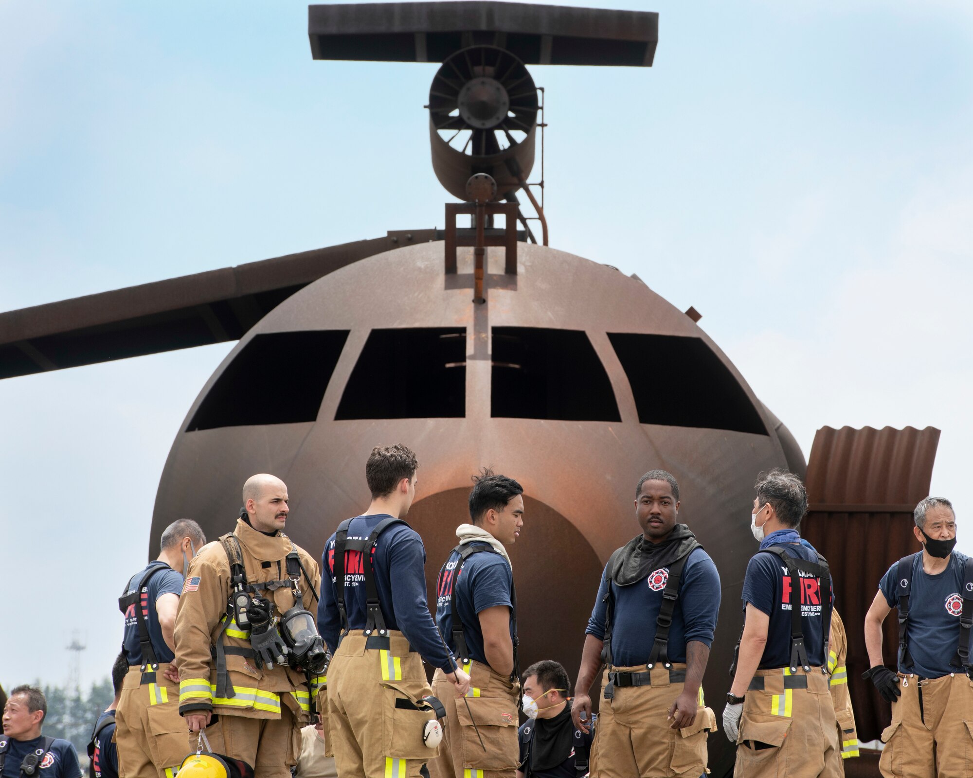 Firefighters with the 374th Civil Engineer Squadron Fire Department talk after providing firefighting techniques and medical response during a major accident response exercise at Yokota Air Base, Japan, May 11, 2022. The MARE tested the base’s response to a simulated F-16 Fighting Falcon crash and the ability to collaborate with mission partners. Due to the support of Naval Air Facility Atsugi, Commander Fleet Activities Yokosuka, Misawa Air Base and Tokyo Fire Department, Fussa Fire Station, this was the largest MARE in Yokota history. (U.S. Air Force photo by Machiko Arita)