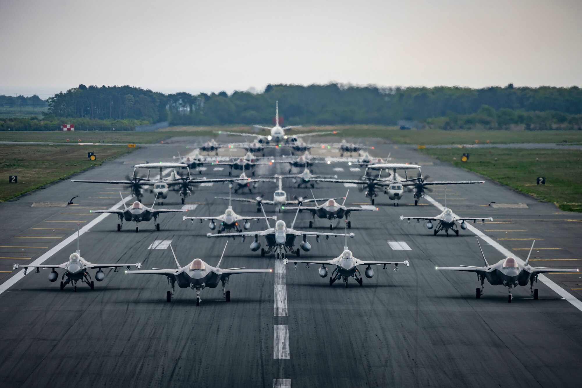 Sixteen U.S. Air Force F-16CM Fighting Falcons, 12 Japan Air Self-Defense Force F-35A Lightning II Joint Strike Fighters, two JASDF E-2C Hawkeyes, one JASDF CH-47 Chinook, one U.S. Navy EA-18G Growler, one USN C-12 Huron, and one USN P-8 Poseidon perform a base capabilities demonstration to culminate a week-long readiness exercise at Misawa Air Base, Japan,  May 13, 2022. The large formation was part of a routine exercise scenario that tested the 35th Fighter Wing's ability to generate airpower in support of the defense of Japan and other partner nations, ensuring the stability and security of a free and open Indo-Pacific region. (U.S. Air Force photo by Airman 1st Class Leon Redfern)