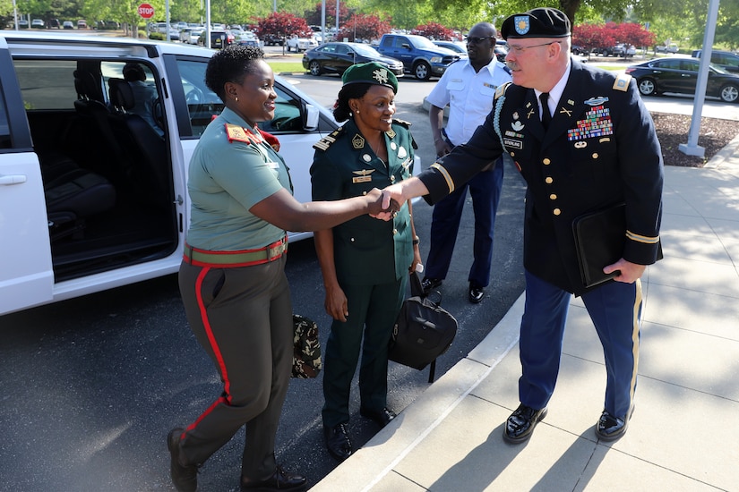 An Army officer shakes hands with another military officer.