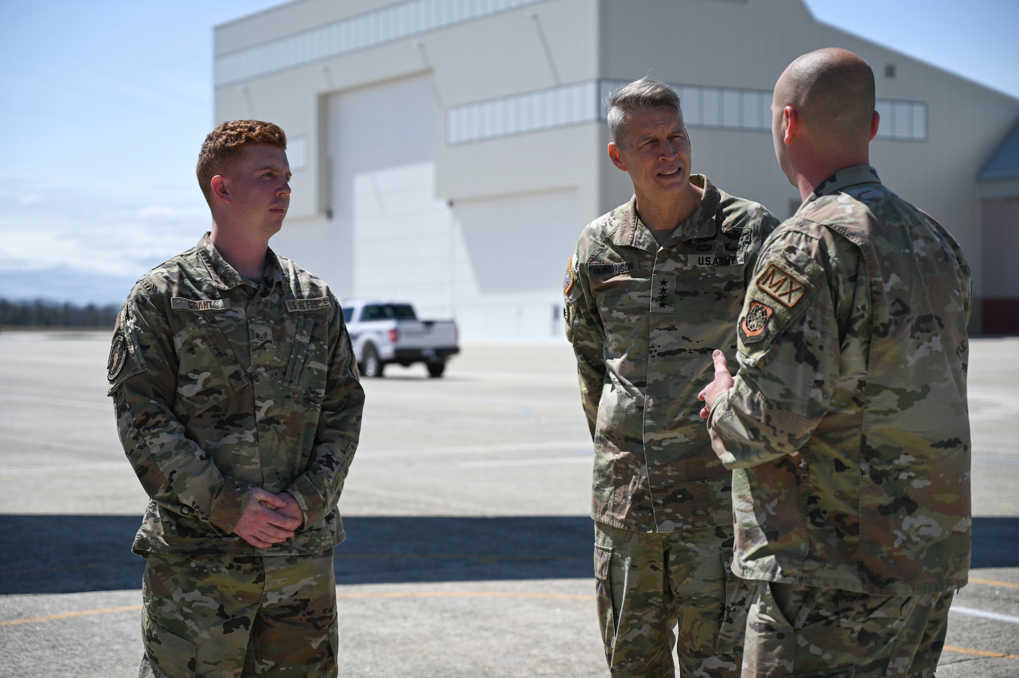 Gen. Daniel Hokanson talks with Airmen under the wing of a KC-46 aircraft