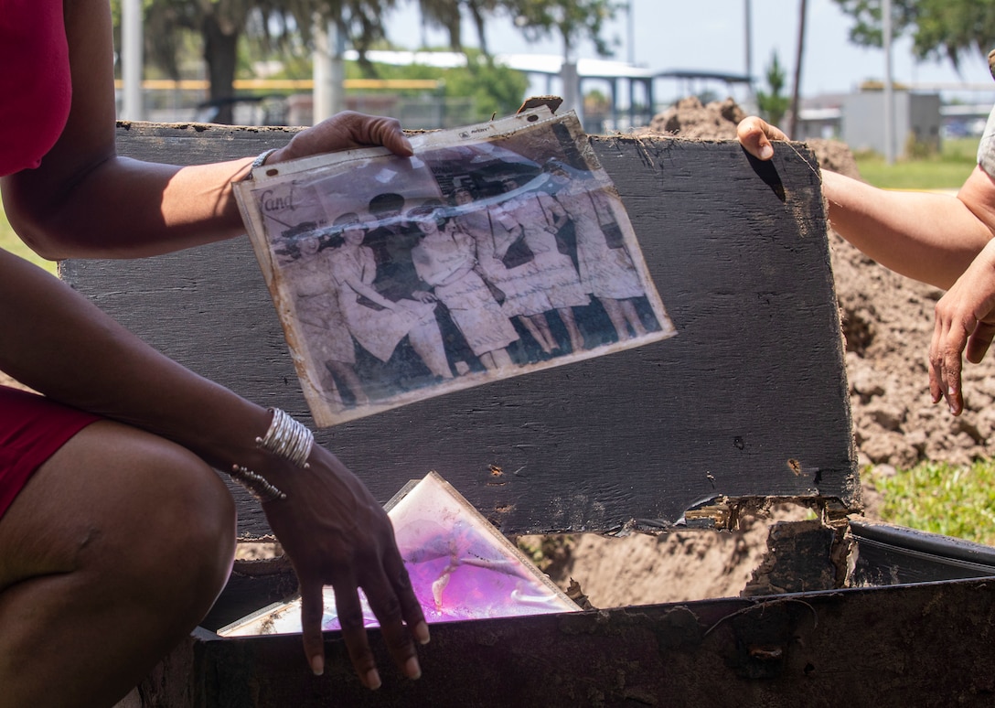 Sgt. Maj. Robin C. Fortner (Ret.) holds up a photo from within the time capsule on Marine Corps Recruit Depot Parris Island S.C., May 5, 2022. Fortner buried multiple items as the Battalion Sergeant Major in 2012 at the time of the celebration.