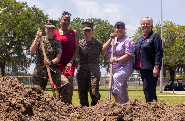 Brig. Gen. Julie L. Nethercot, Marine Corps Recruit Depot Parris Island and Eastern Recruiting Region Commanding General (left), Sgt. Maj. Robin C. Fortner (Ret.) (left center), Lt. Col. Axia R. Dones, 4th Recruit Training Battalion Commanding Officer (center), Col. Maria Marte (Ret.) (center right), and Rhonda Amtower, National President of the Women Marines Association, pose for a photo in front of the exposed time capsule on Marine Corps Recruit Depot Parris Island S.C., May 5, 2022. The time capsule was buried on February 13, 2012 as a part of the celebration of 69 years of continued service by women in the Marine Corps.