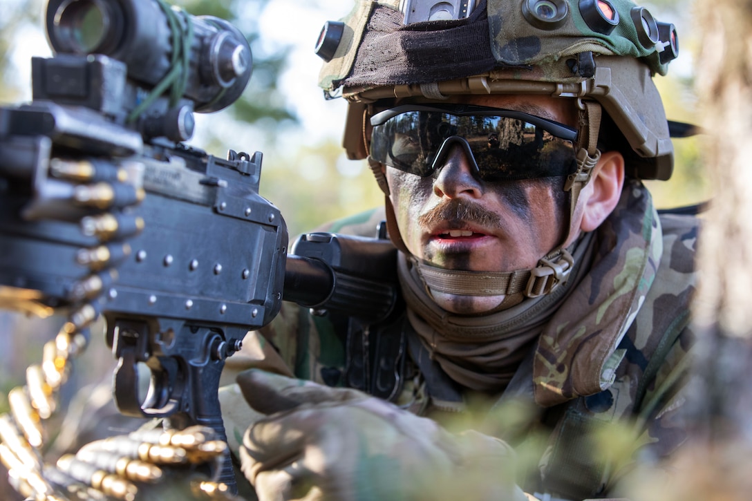 A soldier holds a weapon.