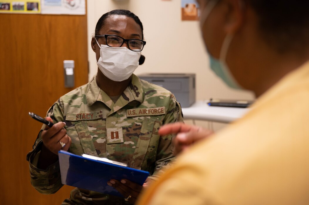 Capt. Durnay Stacy, 375th Healthcare Operations Squadron nurse manager internal medicine, talks with a patient at the 375th Medical Group on Scott Air Force Base, Illinois, May 10, 2022. The 375th HCOS work to provide unparalleled primary and specialty healthcare by embracing a culture of patient safety, professional learning, process improvement, and Wingmanship for the betterment of the patient and families. (U.S. Air Force photo by Staff Sgt. Dalton Williams)
