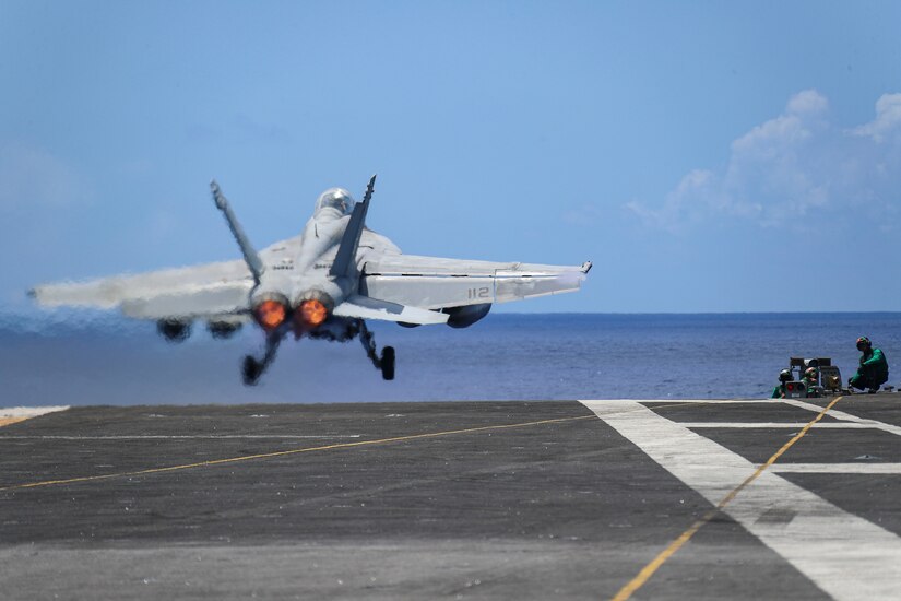 A fighter jet takes off from an aircraft carrier.