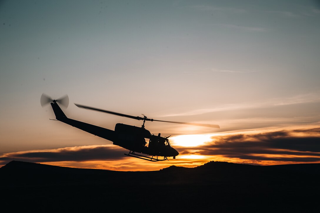 A helicopter lifts off at twilight.