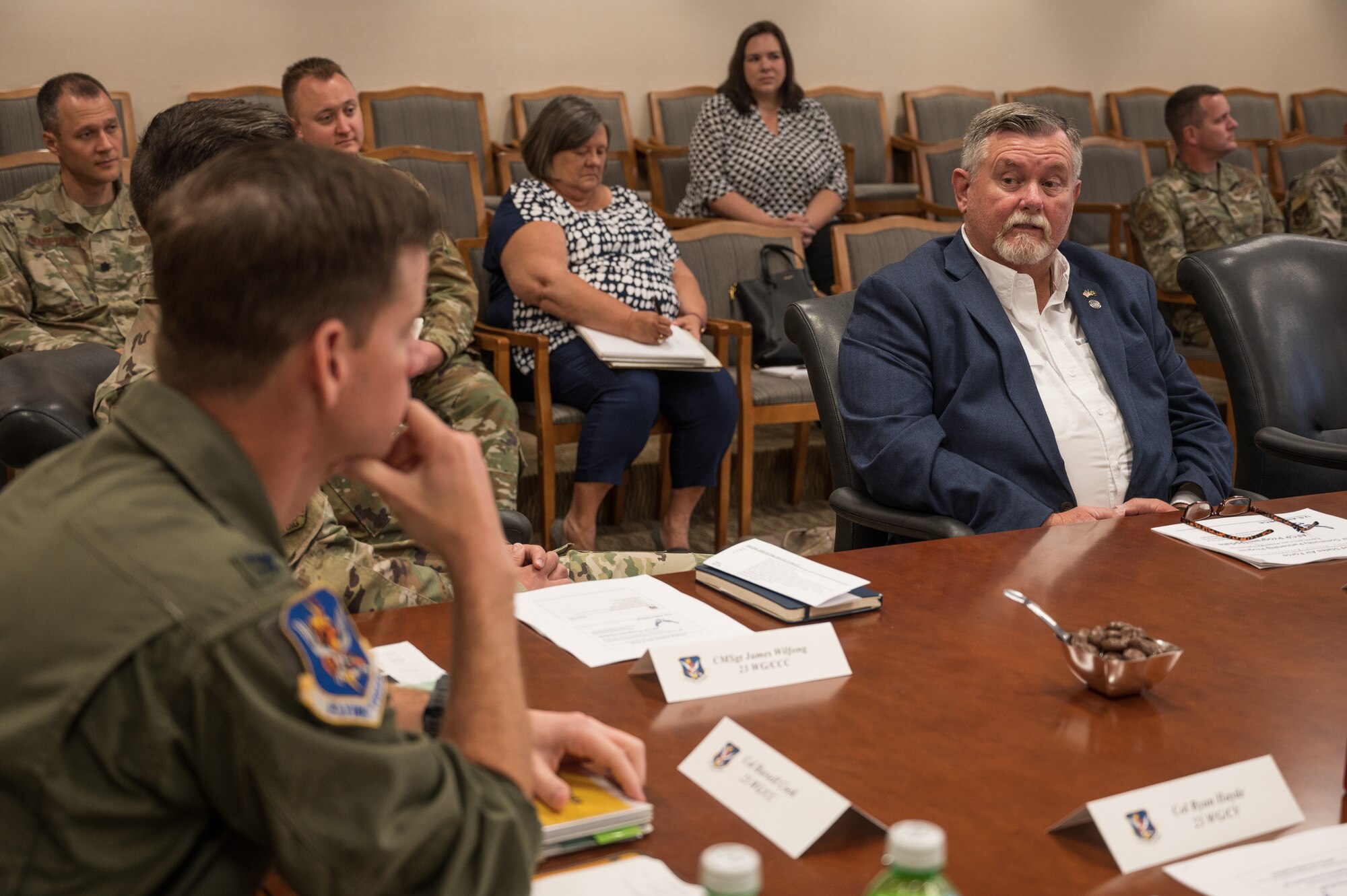 a photo of a man listening during a meeting