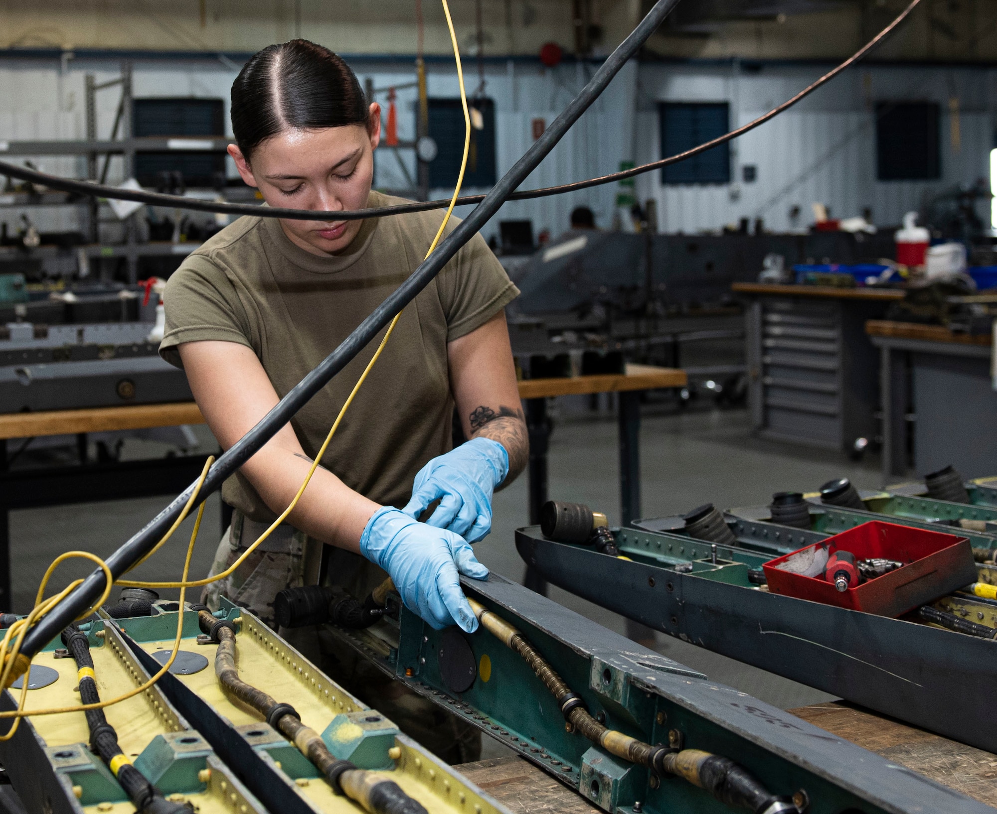 Senior Airman Megan Perkins, 4th Munitions Squadron armament maintenance member, assembles an Adapter Unit-552 at Seymour Johnson Air Force Base, North Carolina, May 12, 2022. The ADU-552 allows for missiles to connect with the pylon so that Airmen can load bombs on F-15E Strike Eagle aircraft. (U.S. Air Force photo by Airman 1st Class Sabrina Fuller)