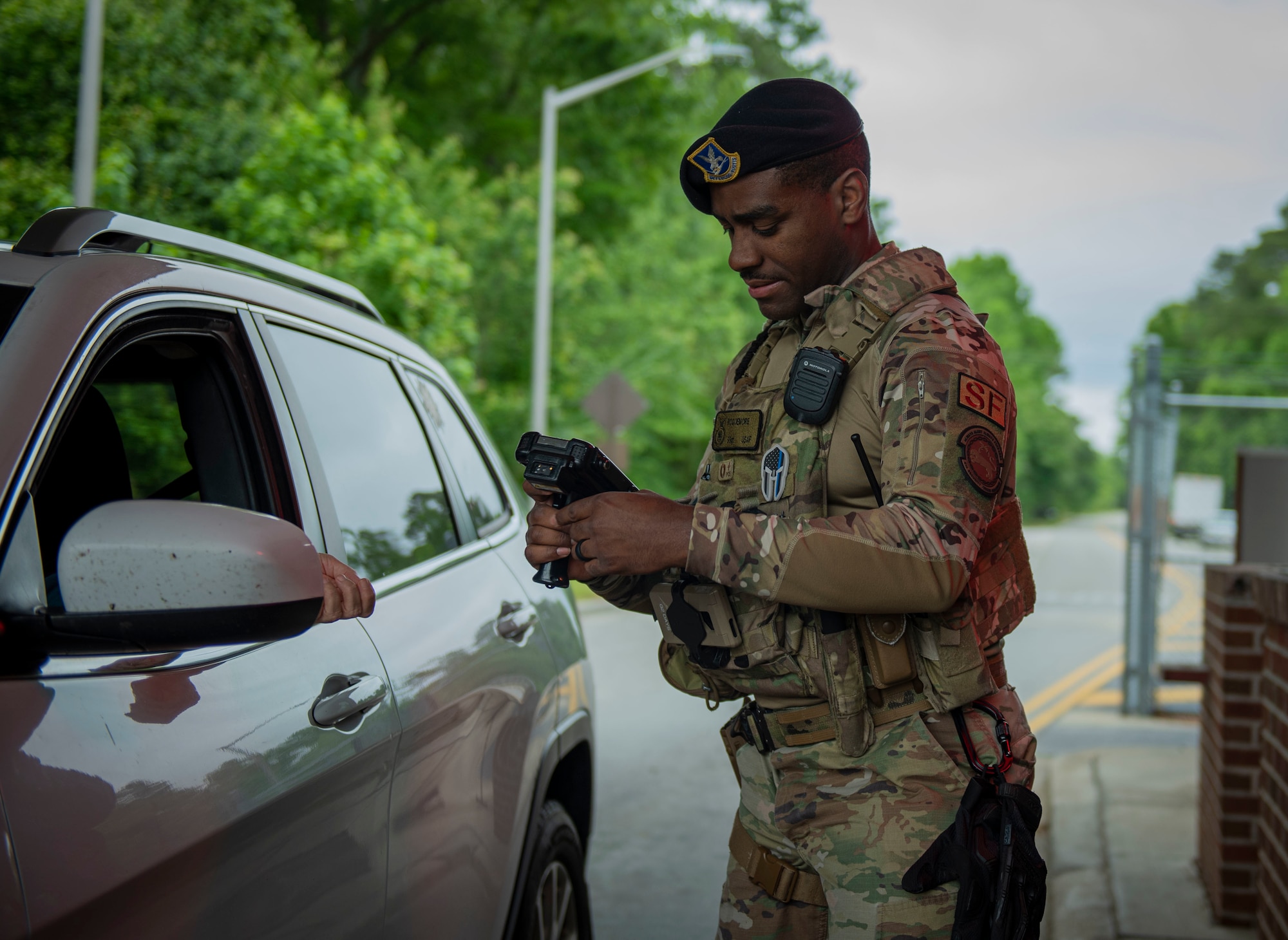 Staff Sgt. Marquez Roquemore, 4th Security Force Squadron patrolman, checks an individual's identification card at Seymour Johnson Air Force Base, North Carolina, May 12, 2022. The 4th SFS mission is to provide force protection and ensure operational readiness. (U.S. Air Force photo by Airman 1st Class Sabrina Fuller)
