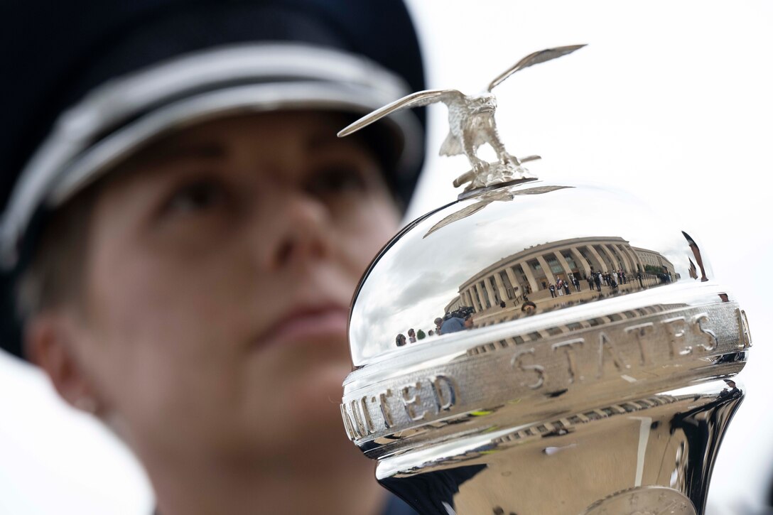 The reflection of the Pentagon is seen from a drum major’s mace.