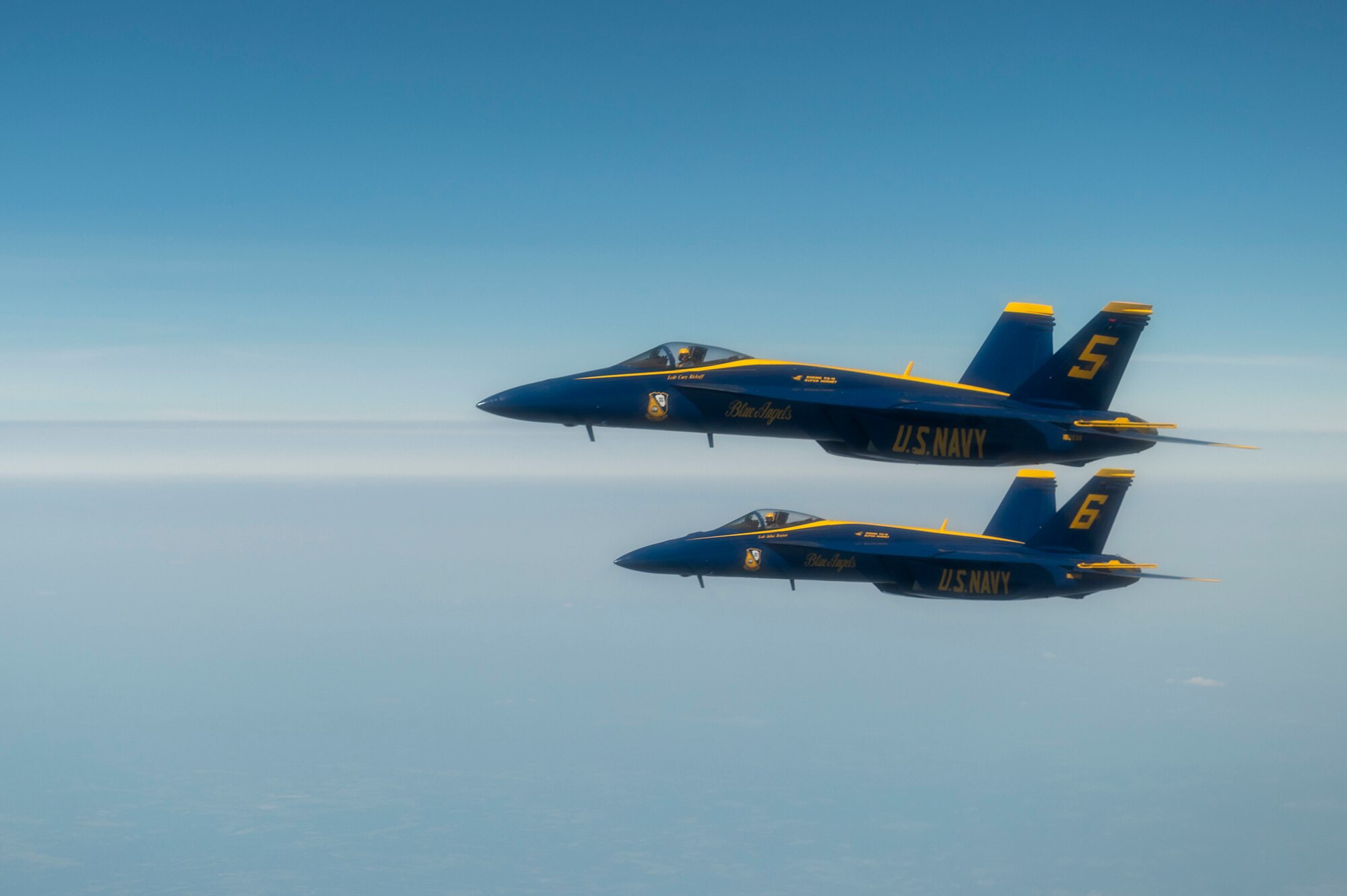 The U.S. Navy Blue Angels fly in formation alongside a KC-46A Pegasus assigned to 916th Air Refueling Wing, after being aerial refueled in the skies over Nebraska, May 11, 2022. The KC-46A helped sustain the Blue Angels by refueling during their flight from Florida to Ellsworth Air Force Base, South Dakota. (U.S. Air Force photo by Senior Airman Kevin Holloway)