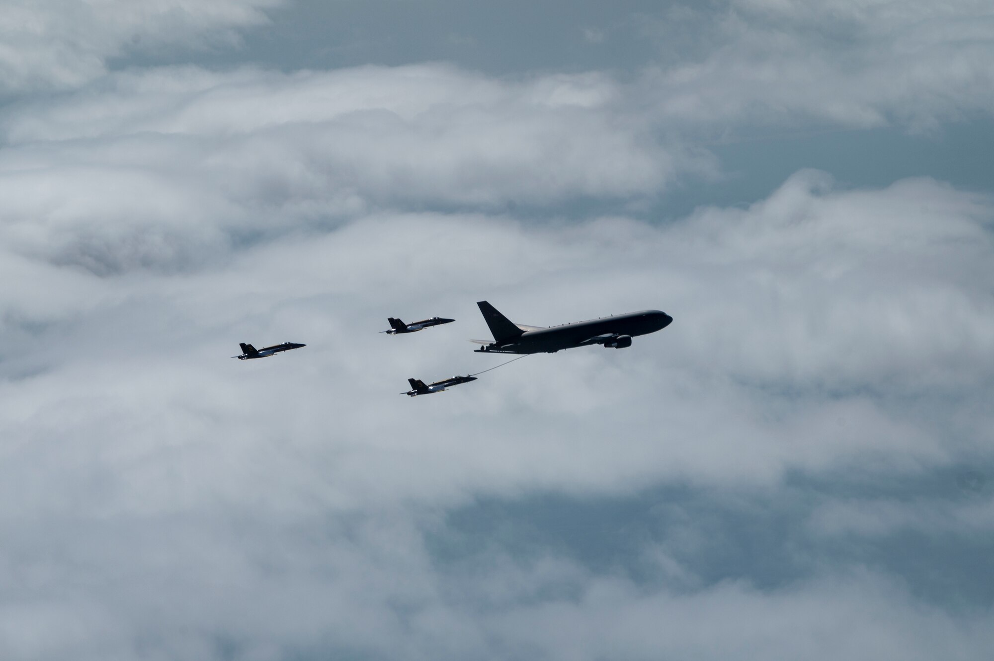 The U.S. Navy Blue Angels fly in formation alongside a KC-46A Pegasus assigned to 916th Air Refueling Wing, after being aerial refueled in the skies over Nebraska, May 11, 2022. The KC-46A helped sustain the Blue Angels by refueling during their flight from Florida to Ellsworth Air Force Base, South Dakota. (U.S. Air Force photo by Senior Airman Kevin Holloway)