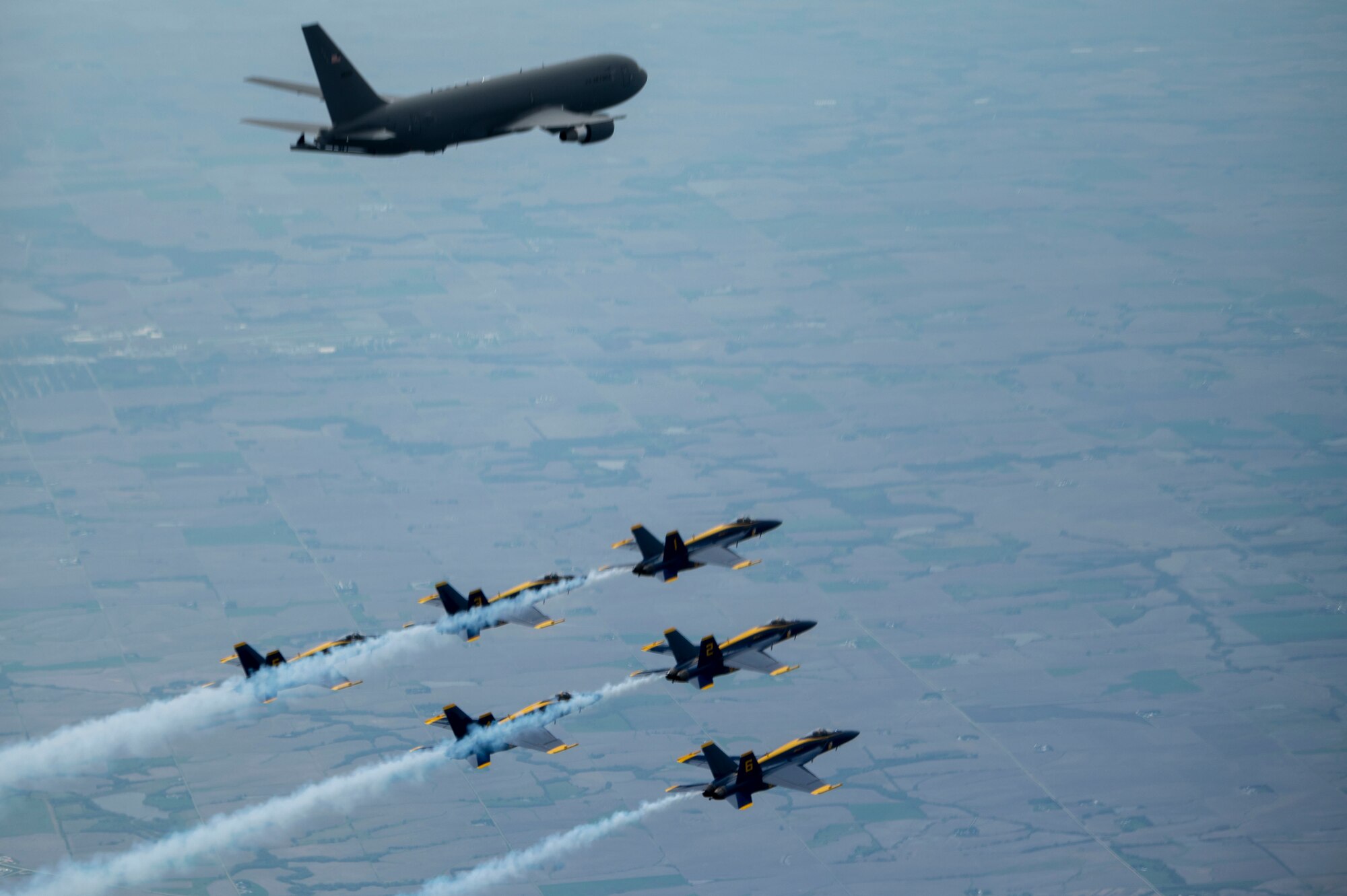 The U.S. Navy Blue Angels fly in formation alongside a KC-46A Pegasus assigned to 916th Air Refueling Wing, after being aerial refueled in the skies over Nebraska, May 11, 2022. The KC-46A helped sustain the Blue Angels by refueling during their flight from Florida to Ellsworth Air Force Base, South Dakota. (U.S. Air Force photo by Senior Airman Kevin Holloway)