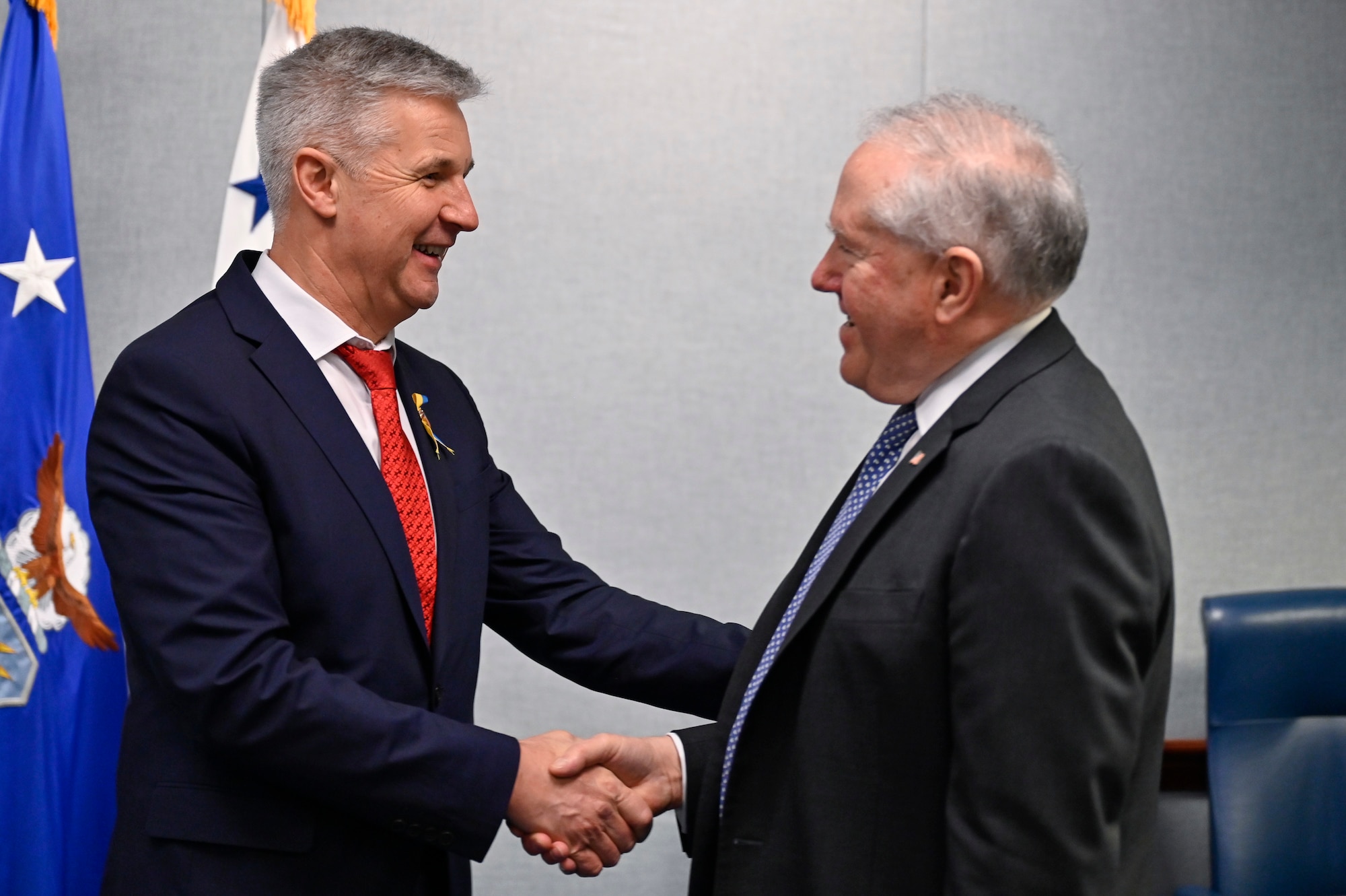 Dr. Artis Pabriks, left, minister of defense and deputy prime minister of Latvia, greets Secretary of the Air Force Frank Kendall.