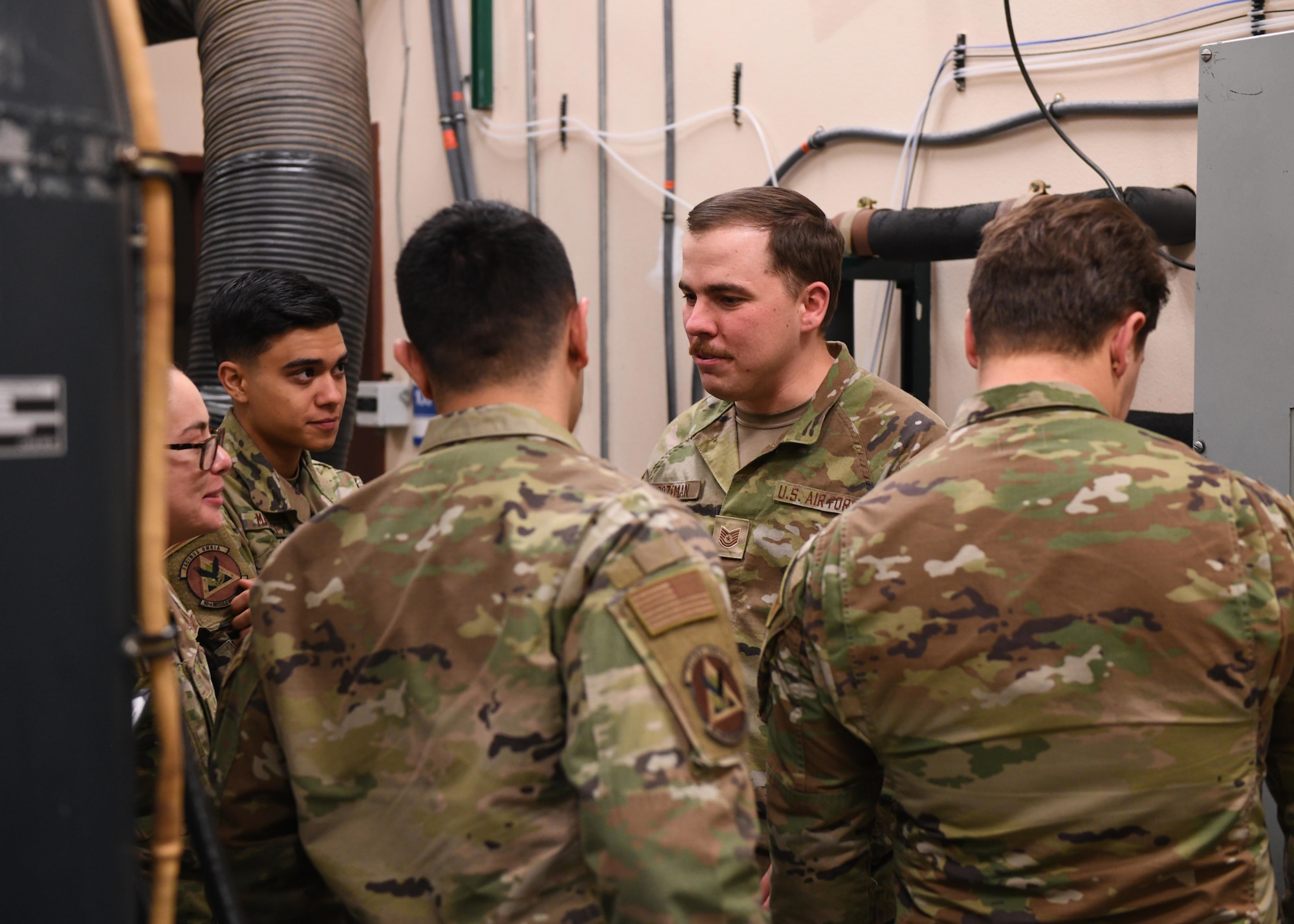 Tech. Sgt. Thomas Bozeman, the facilities maintenance section training non-commissioned officer in charge at the 373rd Training Squadron, Detachment 321, instructs a group of Airmen at F.E. Warren Air Force Base, Wyoming, May 10, 2022. Bozeman helps Airmen gain additional skills needed to complete the mission at the missile complex. (U.S. Air Force photo by Airman 1st Class Darius Frazier.)