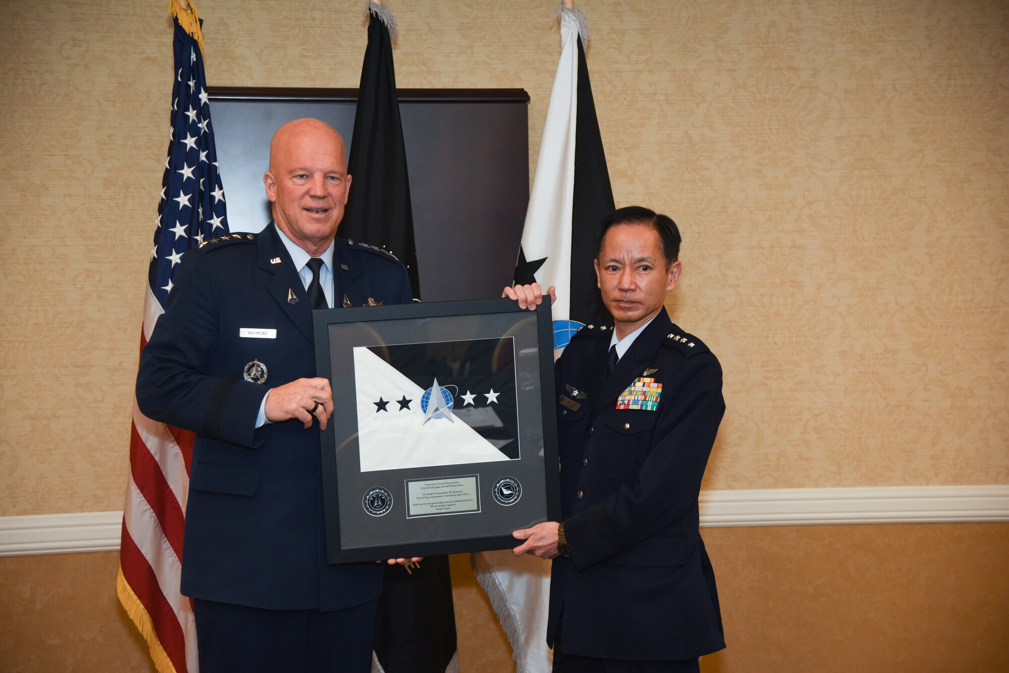 Chief of Space Operations Gen. John W. “Jay” Raymond, presents a gift to Chief of Staff Japan Air Self Defense Force Gen. Shunji Izutsu.