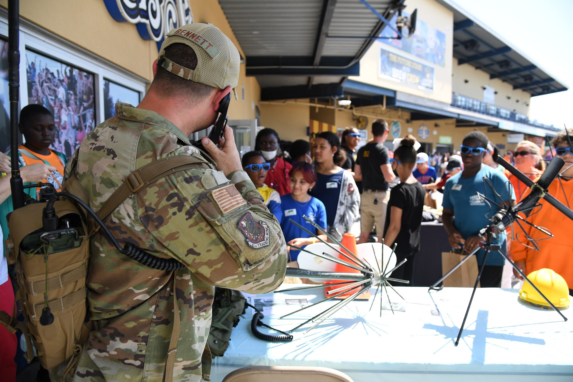 U.S. Air Force Staff Sgt. Blake Bennett, 338th Training Squadron instructor, provides a demonstration on radio frequency transmissions equipment to students and teachers from Gulfport's Central Elementary School during the Biloxi Shuckers Education Day event in Biloxi, Mississippi, May 11, 2022. The event allowed Airmen from the 81st Training Group to set up training equipment displays for local school-aged children to view during the Biloxi Shuckers' game. (U.S. Air Force photo by Kemberly Groue)