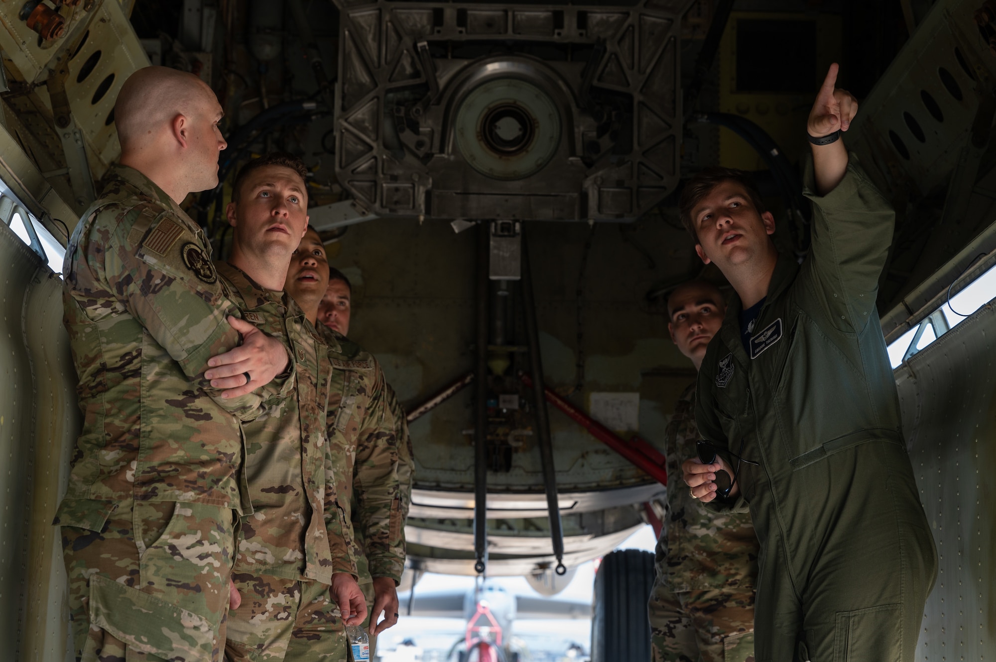 First Lt. Bo Cain, 20th Bomb Squadron weapon systems officer, points out key equipment in the bomb bay of a B-52H Stratofortress during a Striker Stripe tour May 13, 2022 at Barksdale Air Force Base, Louisiana. Air Force Global Strike Command non-commissioned officers attended a five-day developmental seminar where they focused on leadership skills and the tour provided a deeper understanding of the bomb wing mission. (U.S. Air Force photo by Airman 1st Class Chase Sullivan)