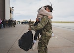 A U.S. Air Force Airman assigned to the 140th Wing, Colorado Air National Guard embraces a loved one after returning from a deployment April 13, 2022, at Buckley Space Force Base, Aurora, Colorado. Airmen from the 140th Wing were deployed in support of U.S. Central Command. (U.S. Air National Guard photo by Senior Airman Mira Roman)