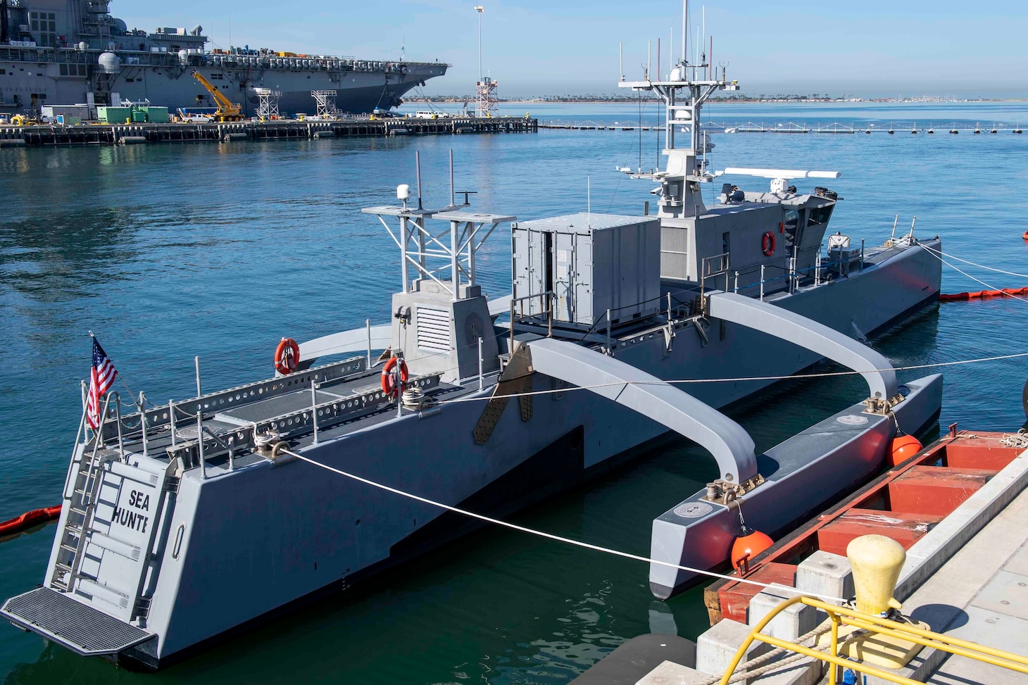 The medium-displacement unmanned surface vessel Sea Hunter sits pierside at Naval Base San Diego, during the Unmanned Surface Vessel Division (USDIV) One Establishment ceremony.