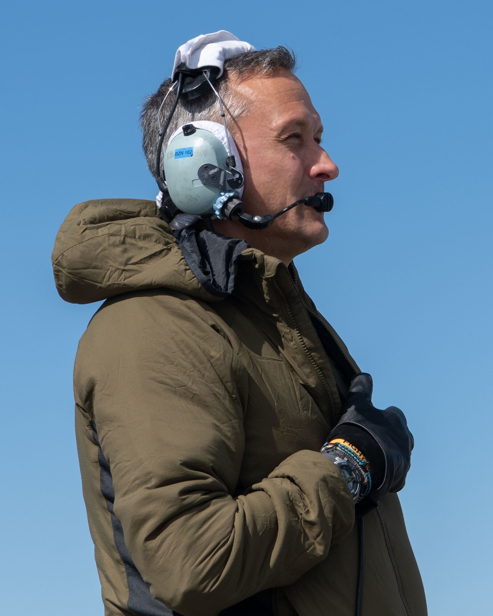 A photo of a man speaking into a headset