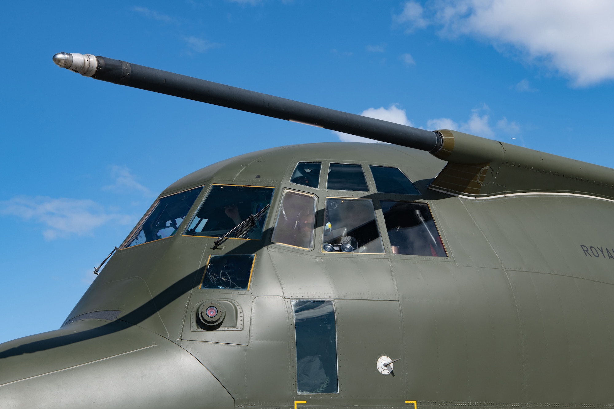 a photo of a pilot in a green plane