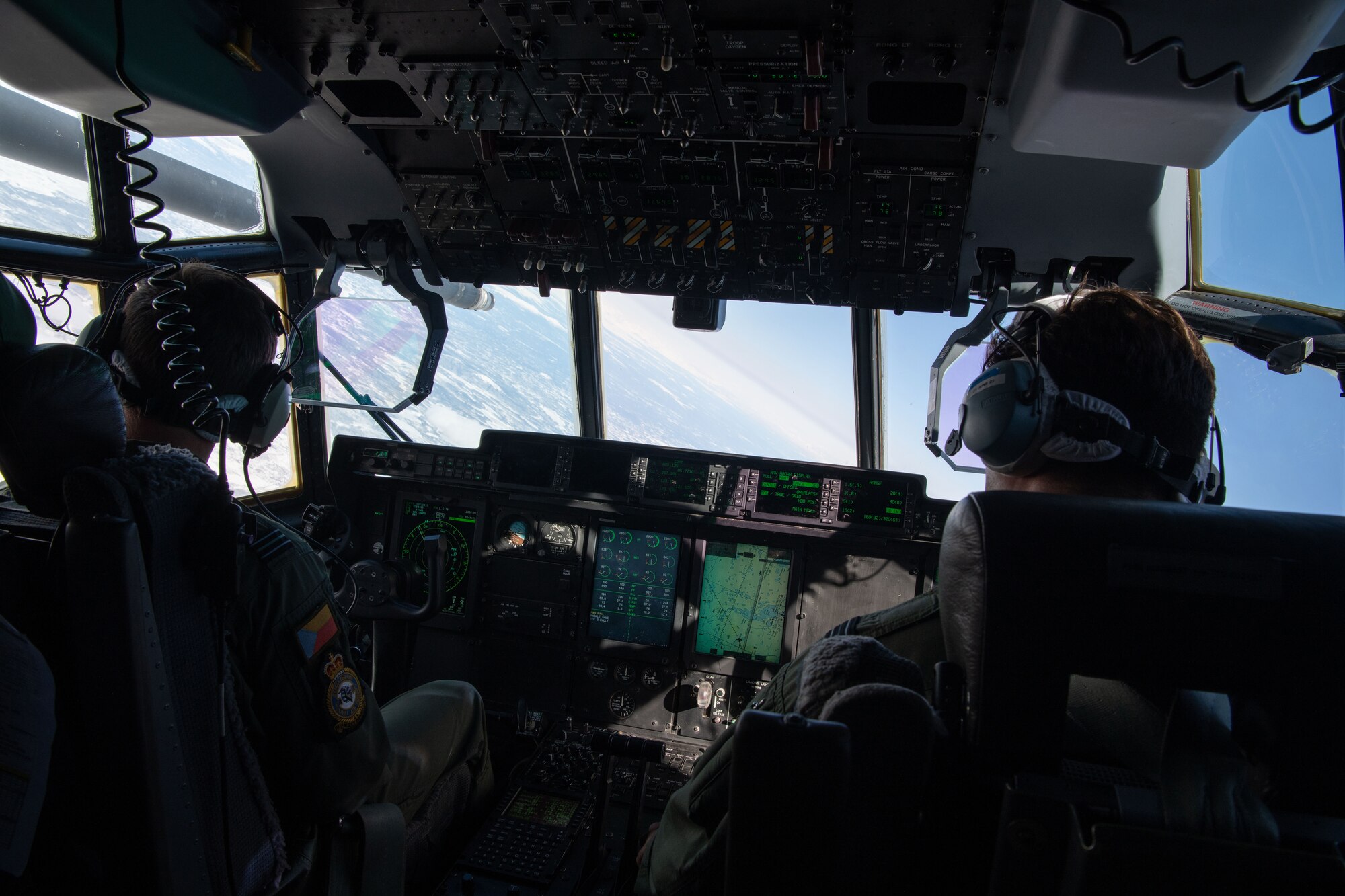 A photo of pilots flying over mountains