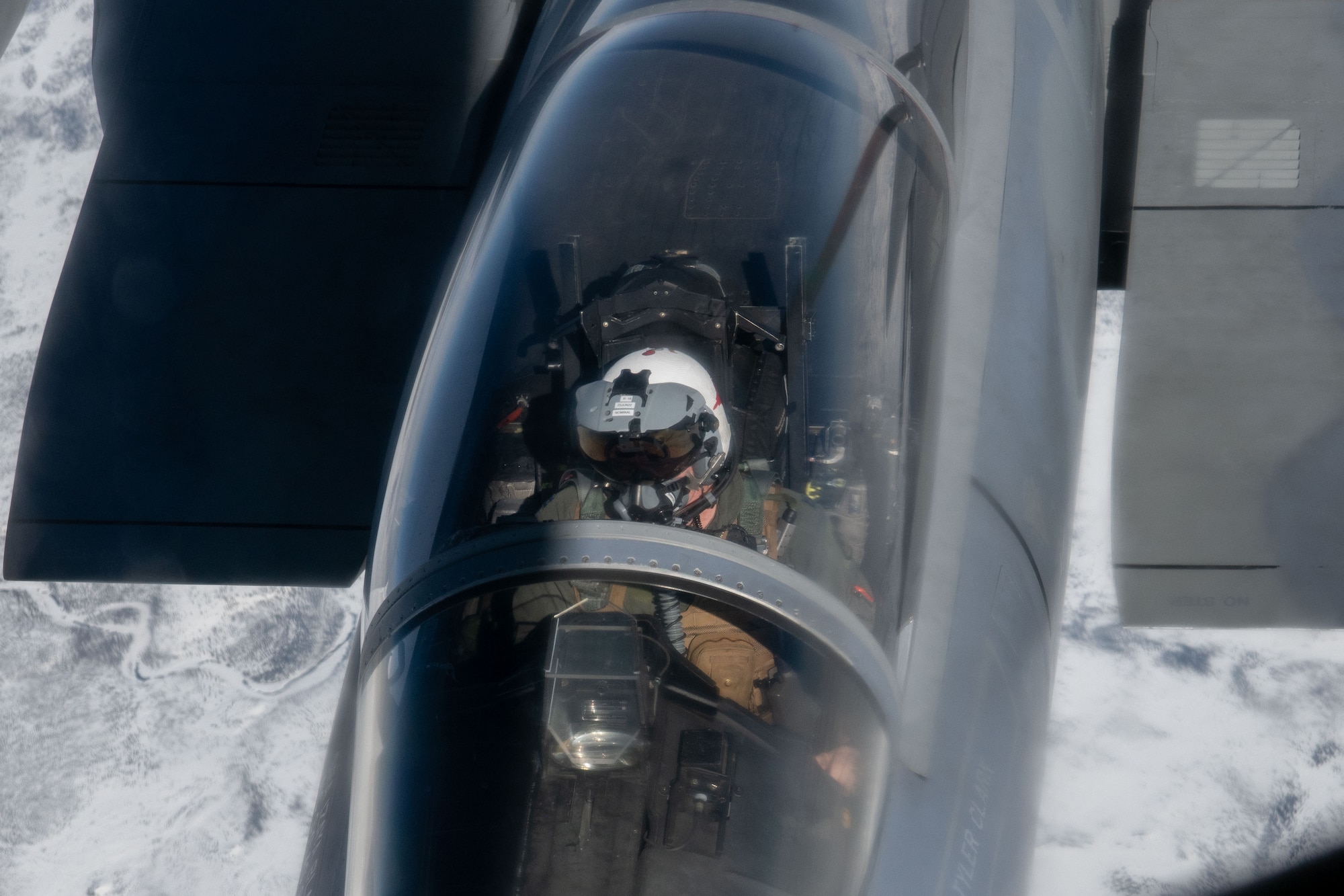 A photo of a plane refueling while flying