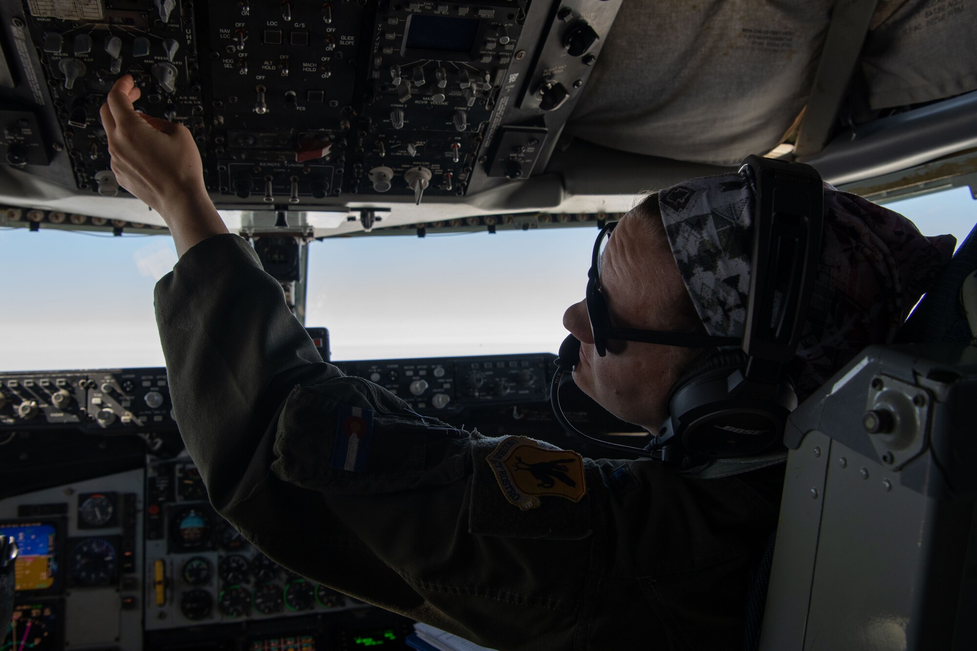 A photo of a pilot changing controls