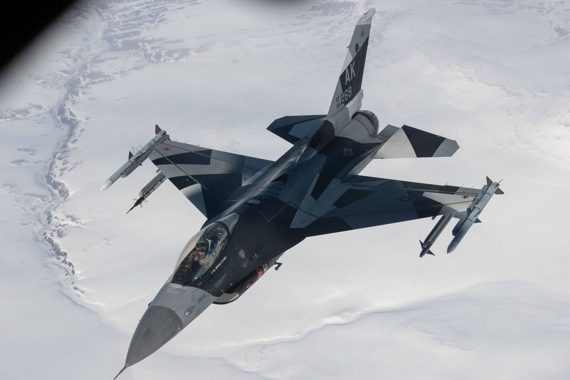 A photo of a plane flying over mountains