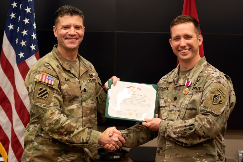 Lt. Col. Joseph Sahl (Left), U.S. Army Corps of Engineers Nashville District commander, presents the Meritorious Service Medal to Lt. Col. Nathan Branen, Nashville District deputy commander, during a ceremony at the district headquarters May 13, 2022. Sahl made the presentation on behalf of Col. Kimberly A. Peeples, Great Lakes and Ohio River Division commander. The medal recognizes Branen’s extraordinary leadership and tireless work ethic that ensured the district’s success across its diverse and complex missions. (USACE Photo by Lee Roberts)