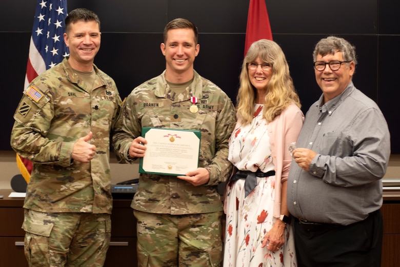 (Left to Right) Lt. Col. Joseph Sahl, U.S. Army Corps of Engineers Nashville District commander; Lt. Col. Nathan Branen, Nashville District deputy commander; Branen’s father Robert Branen; and Branen’s mother Anne Branen; pose together following the commander’s presentation of the Meritorious Service Medal at the district headquarters May 13, 2022, in Nashville, Tennessee. (USACE Photo by Lee Roberts)
