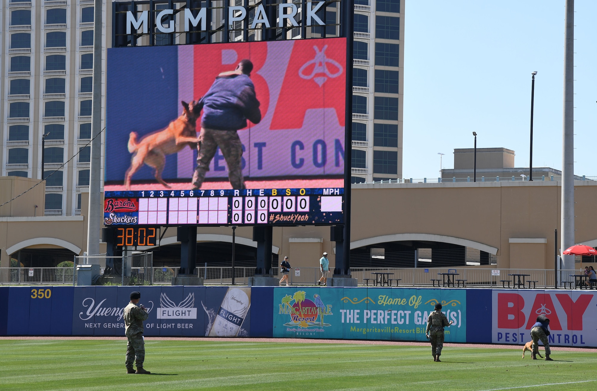 Members of the 81st Security Forces Squadron participate in a military working dog demonstration during the Biloxi Shuckers Education Day event in Biloxi, Mississippi, May 11, 2022. The event allowed Airmen from the 81st Training Group to set up training equipment displays for local school-aged children to view during the Biloxi Shuckers' game. (U.S. Air Force photo by Kemberly Groue)