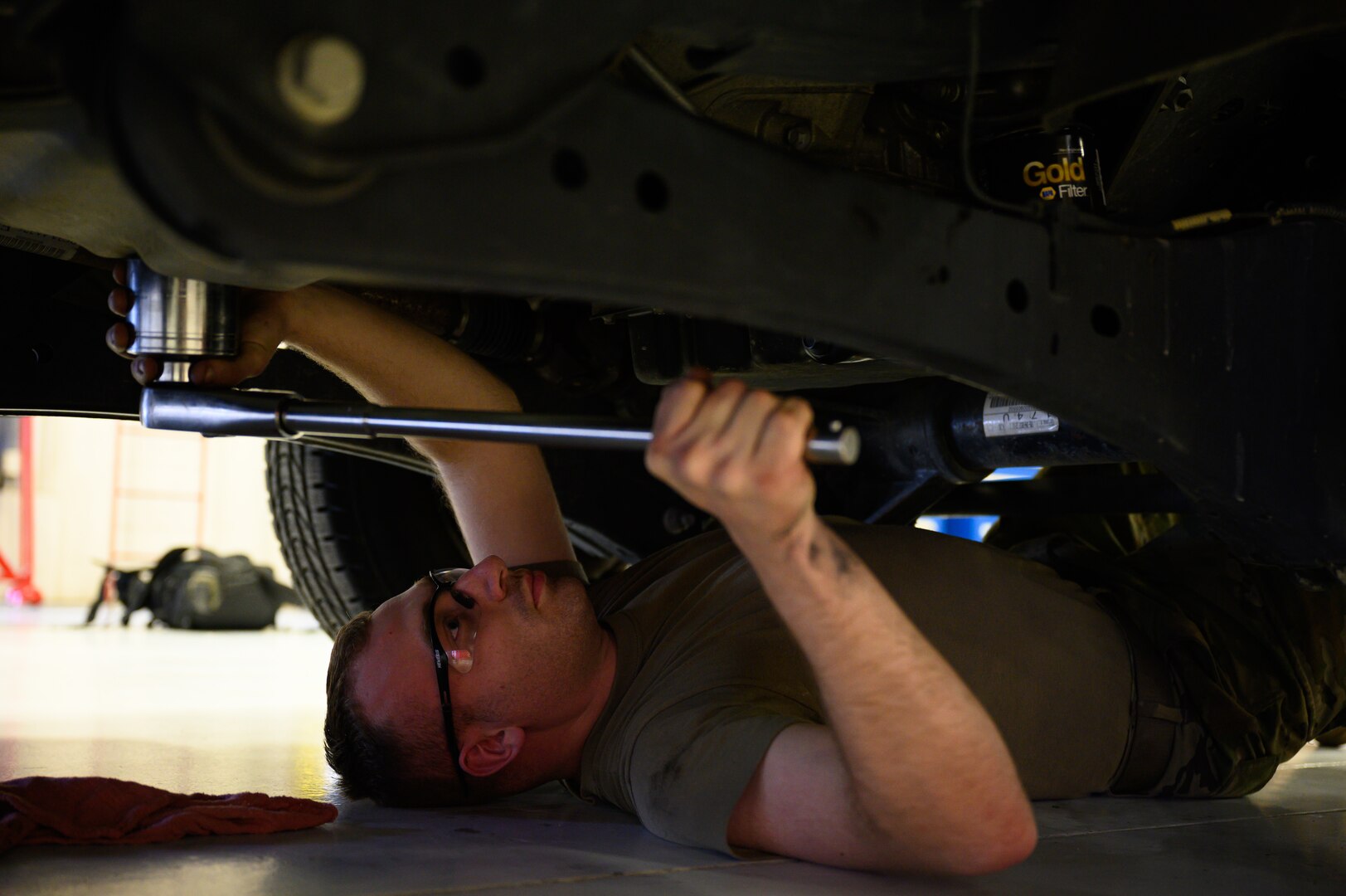 U.S. Air Force Staff Sgt. Connor Peters, a 354th Logistics Readiness Squadron vehicle management supervisor, conducts transmission service on a vehicle during RED FLAG-Alaska 22-1 on Eielson Air Force Base, Alaska, May 11, 2022.