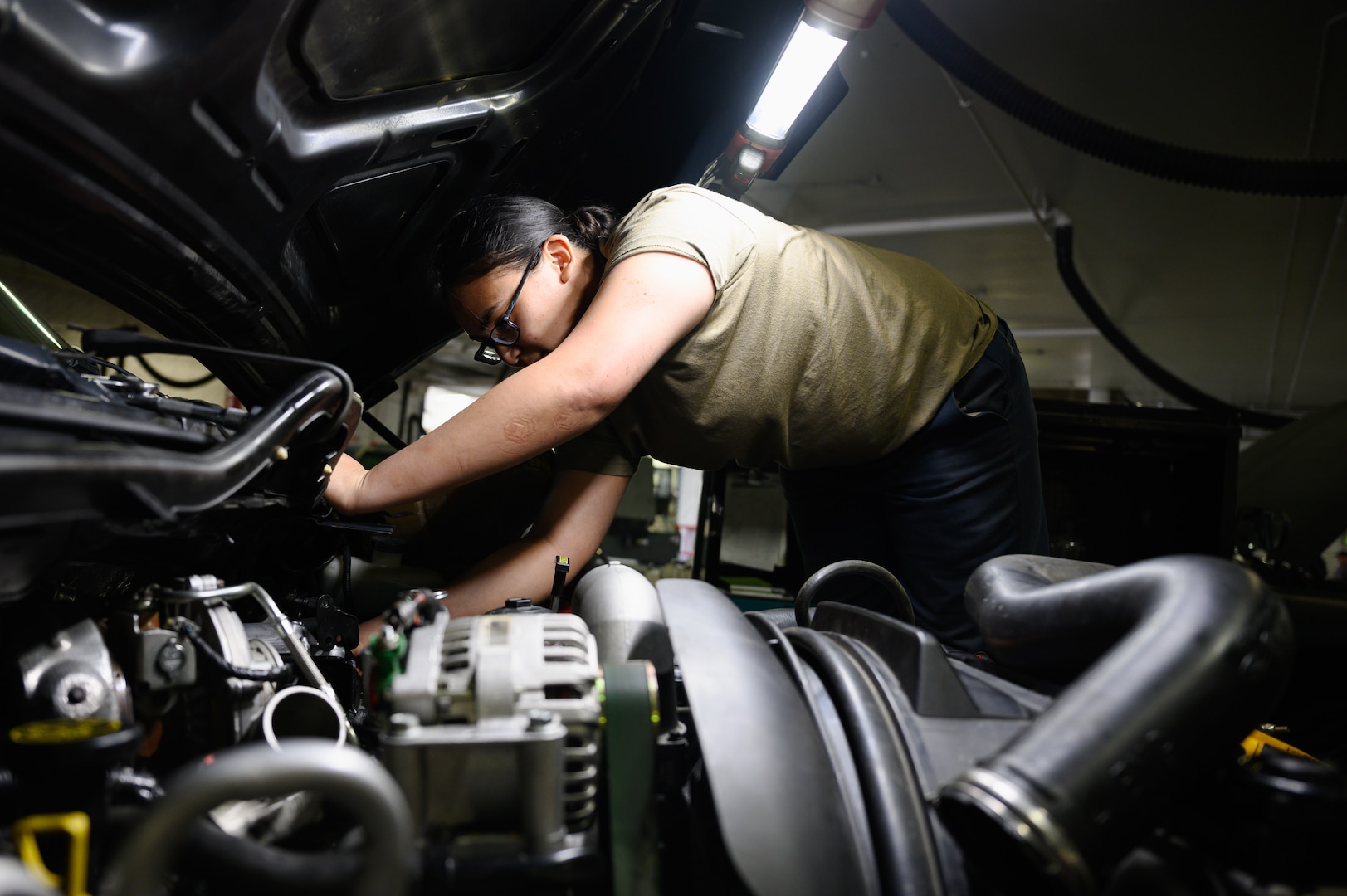 U.S. Air Force Airman 1st Class Azure Agricula-McCormick, a 354th Logistics Readiness Squadron vehicle maintenance journeyman, performs preventative maintenance on a vehicle during RED FLAG-Alaska 22-1 on Eielson Air Force Base, Alaska, May 11, 2022.