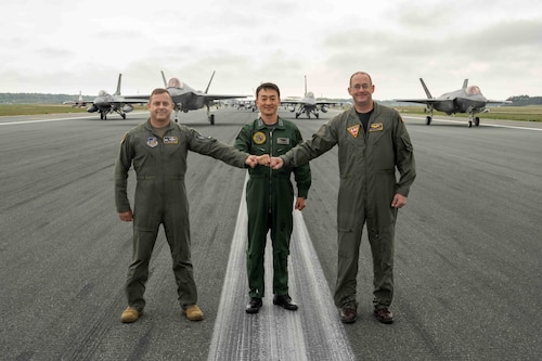 U.S. Air Force Col. Jesse J. Friedel, 35th Fighter Wing commander, Japan Air Self-Defense Force Maj. Gen. Takahiro Kubota, 3rd Air Wing commander, and U.S. Navy Capt. Paul Hockran, Naval Air Facility Misawa commanding officer, stand in front of aircraft assembled for a base capabilities demonstration to culminate a week-long readiness exercise at Misawa Air Base, Japan, May 13, 2022. The large formation displays the joint, bilateral capabilities of Misawa Air Base, with a mission to protect U.S. interests in the Pacific, defend Japan and deter adversaries through our presence, readiness, and ability to project combat air power. (U.S. Air Force photo by Airman 1st Class Joao Marcus Costa)