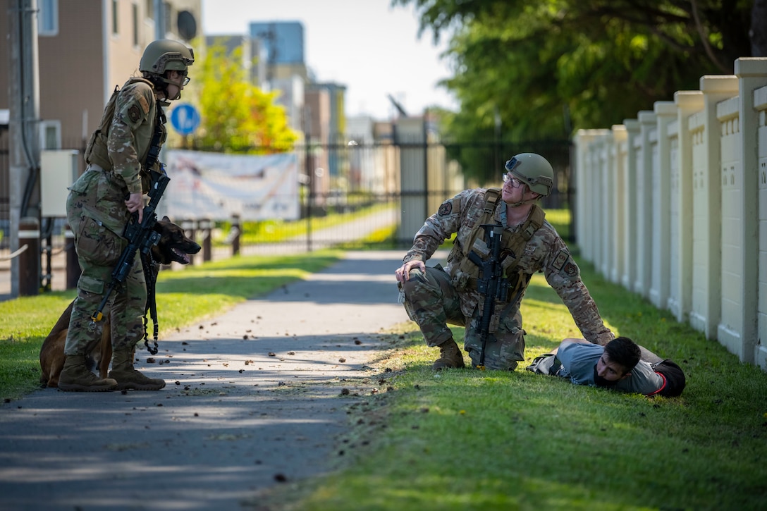 U.S. Airmen assigned to the 35th Security Forces Squadron simulate a capture and restrain of a protestor who broke through the gate during exercise Beverly Sunrise 22-04 at Misawa Air Base, Japan, May 10, 2022. The exercise tested Airmen’s abilities to support Agile Combat Employment concepts to ensure forward-deployed forces in the Indo-Pacific region are ready to protect and defend the United States, allies, and partner interests at a moment’s notice. (U.S. Air Force photo by Airman 1st Class Leon Redfern)