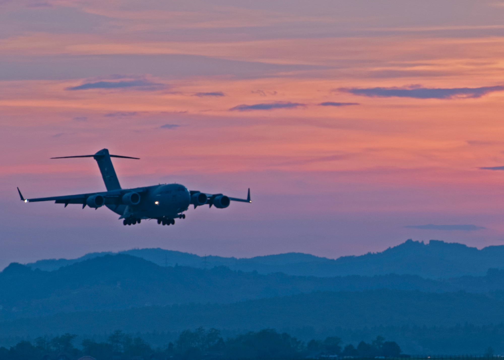 A C-17 Globemaster III prepares to land during Exercise Swift Response at Cerklje Air Base, Slovenia, May 10, 2022. Approximately 9,000 service members from 17 Allied and partner nations will participate in Swift Response, including approximately 2,700 U.S. Soldiers and Airmen. (U.S. Air Force photo by Staff Sgt. Zoe Thacker)