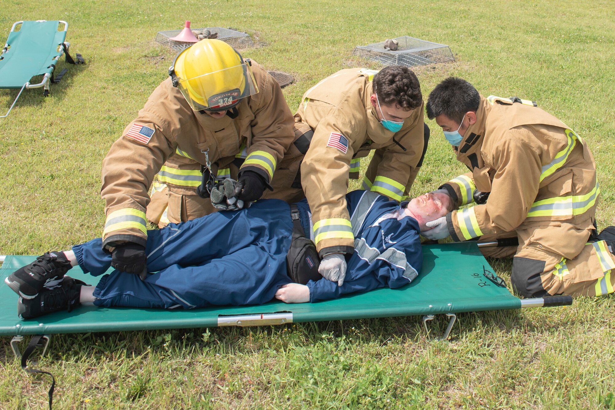 Firefighters with the 374th Civil Engineer Squadron Fire Department prepare to transport a simulated injured person during a major accident response exercise at Yokota Air Base, Japan, May 11, 2022. The MARE tested the base’s response to a simulated F-16 Fighting Falcon crash and the ability to collaborate with mission partners. Due to the support of Naval Air Facility Atsugi, Commander Fleet Activities Yokosuka, Misawa Air Base and Tokyo Fire Department, Fussa Fire Station, this was the largest MARE in Yokota history. (U.S. Air Force photo by Machiko Arita)